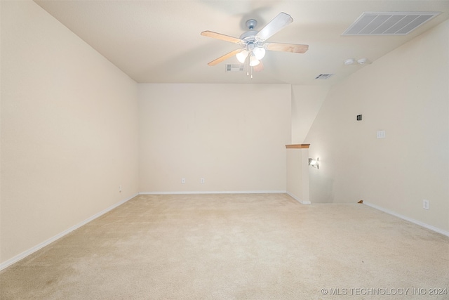 empty room featuring light carpet, ceiling fan, and lofted ceiling