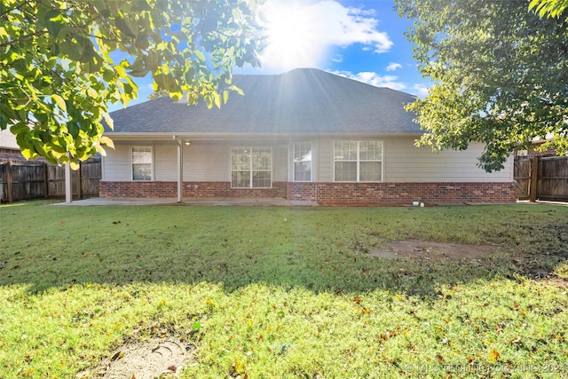 back of house with a lawn