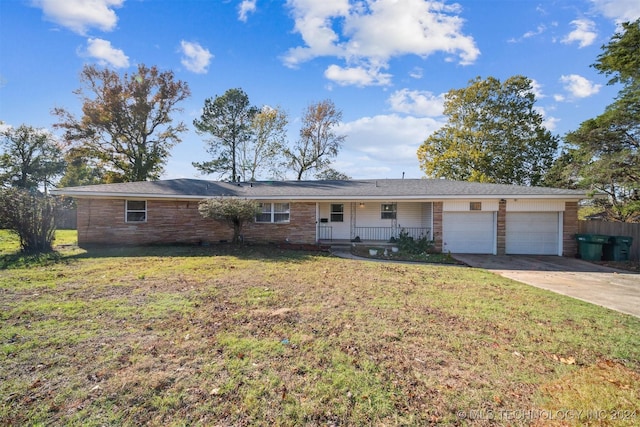 single story home with a porch, a garage, and a front lawn