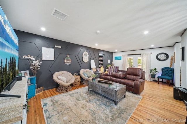 living room featuring french doors and light wood-type flooring