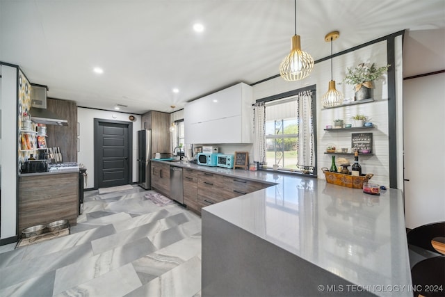 kitchen featuring sink, appliances with stainless steel finishes, hanging light fixtures, dark brown cabinetry, and white cabinets