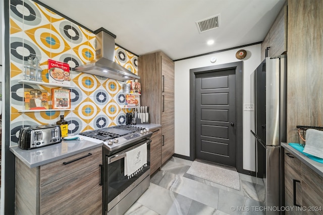 kitchen with tasteful backsplash, wall chimney range hood, and stainless steel gas range