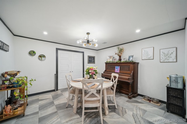 dining space with ornamental molding and a chandelier