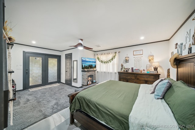 bedroom featuring ornamental molding, access to outside, a fireplace, and ceiling fan