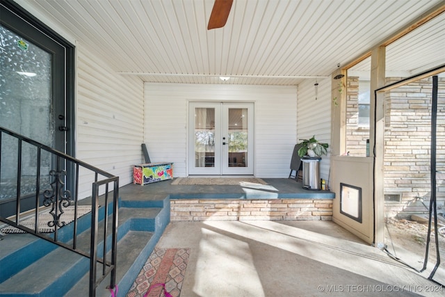 view of exterior entry featuring ceiling fan and french doors