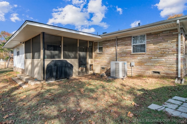 back of property featuring central AC and a sunroom