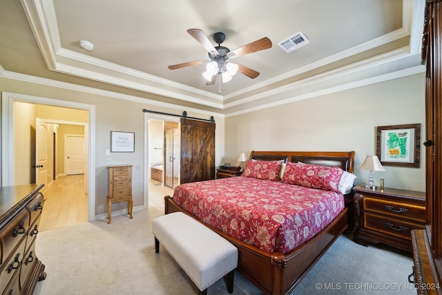 carpeted bedroom with a tray ceiling, ceiling fan, ensuite bathroom, crown molding, and a barn door