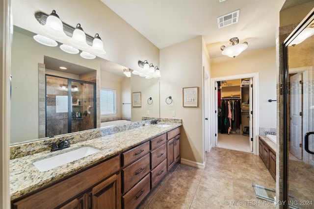 bathroom with tile patterned floors, vanity, and independent shower and bath