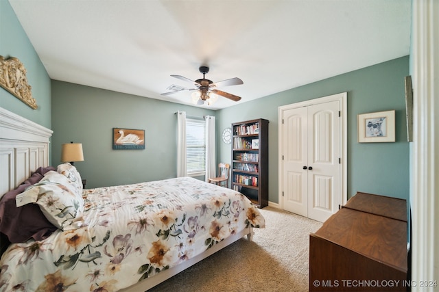 carpeted bedroom with ceiling fan and a closet