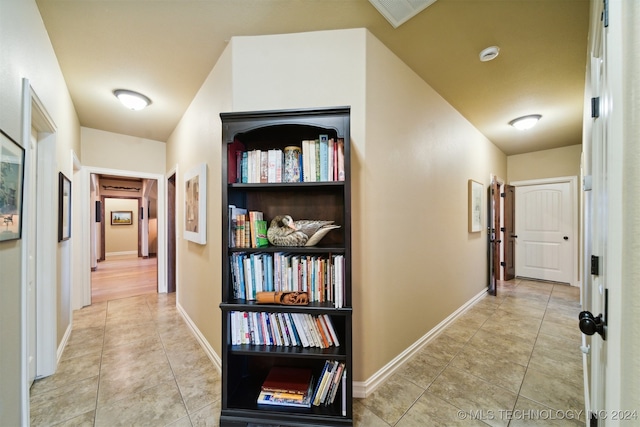 hall featuring light tile patterned floors