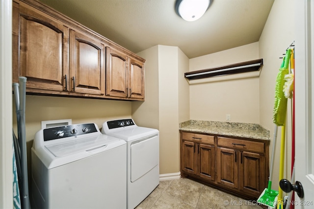 laundry room featuring cabinets and separate washer and dryer