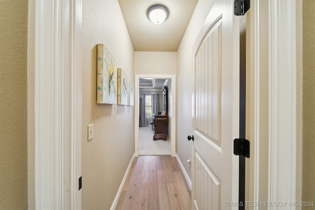 hallway with light hardwood / wood-style flooring