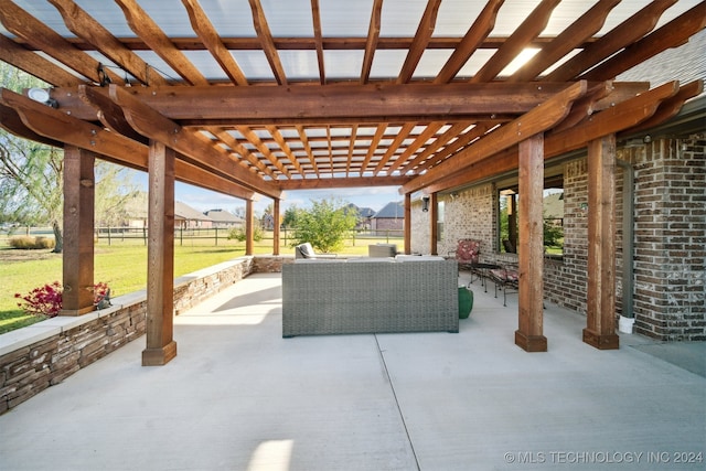 view of patio featuring an outdoor living space and a pergola