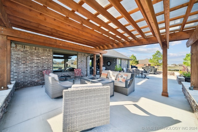 view of patio / terrace featuring a pergola and an outdoor living space with a fire pit