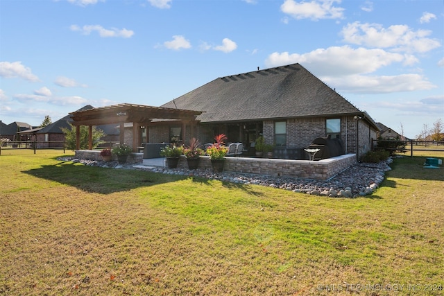 rear view of property featuring a patio, a pergola, and a yard