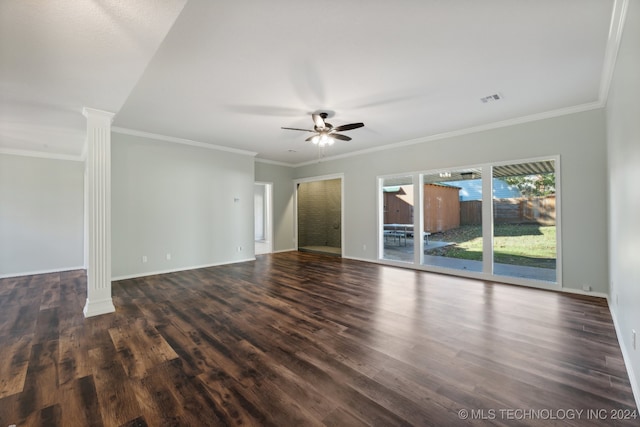 spare room with decorative columns, dark hardwood / wood-style floors, crown molding, and ceiling fan