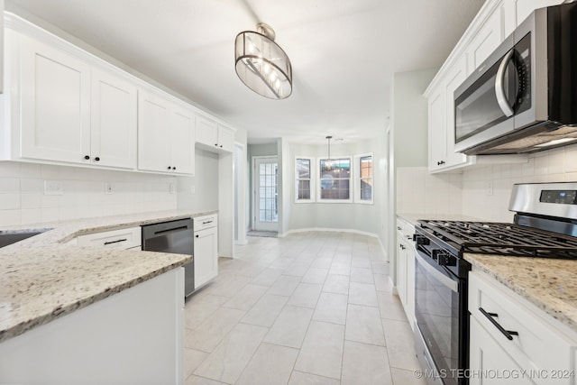 kitchen featuring a notable chandelier, decorative light fixtures, white cabinetry, and stainless steel appliances