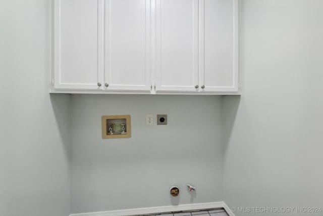 laundry room featuring cabinets, hookup for a washing machine, tile patterned floors, electric dryer hookup, and hookup for a gas dryer