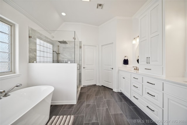 bathroom featuring independent shower and bath, vanity, lofted ceiling, and ornamental molding