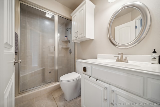 bathroom with toilet, vanity, an enclosed shower, and tile patterned floors