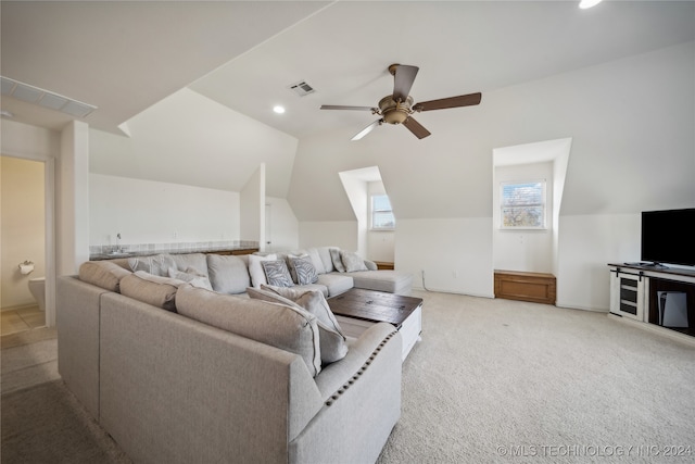 living room featuring lofted ceiling, light carpet, and ceiling fan