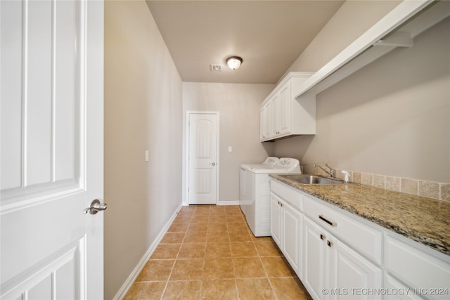 laundry room featuring cabinets, light tile patterned flooring, washer and dryer, and sink