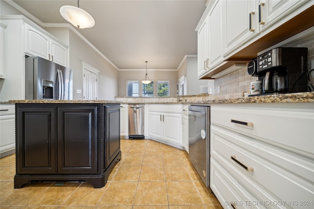 kitchen with appliances with stainless steel finishes, light stone counters, a center island, and decorative light fixtures