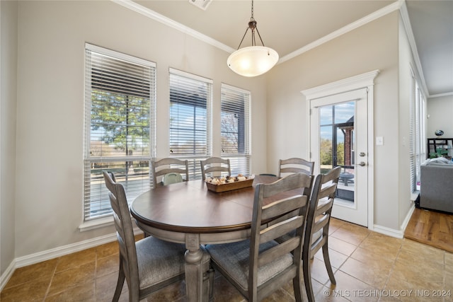 dining space featuring a healthy amount of sunlight and crown molding