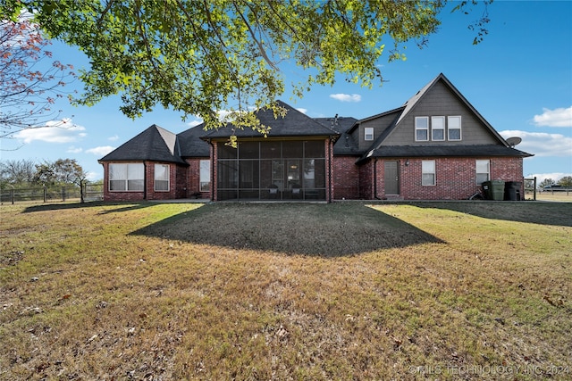 exterior space with a sunroom and a lawn