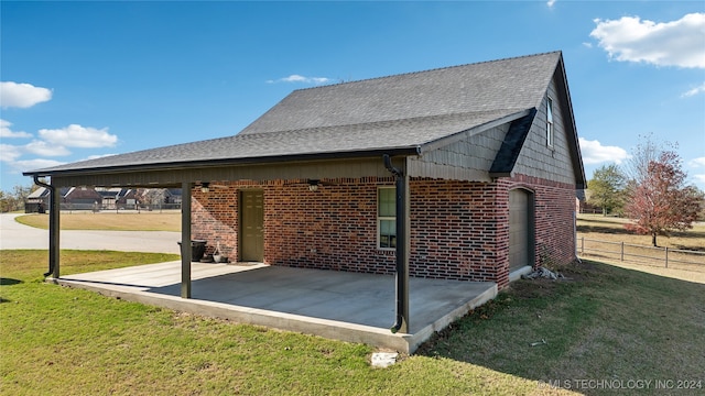 view of property exterior with a patio and a yard