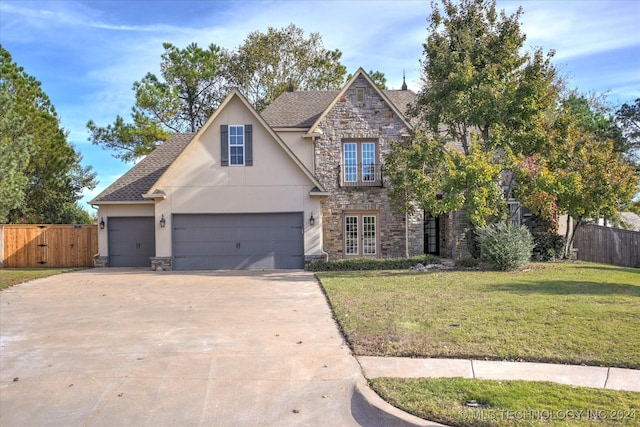 view of front facade featuring a front yard and a garage