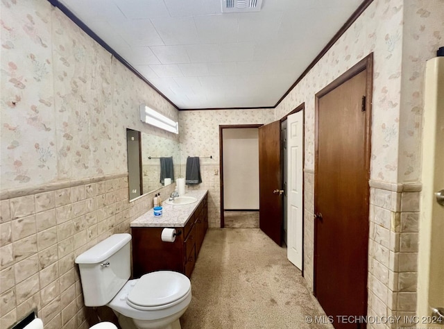 bathroom featuring vanity, toilet, and crown molding