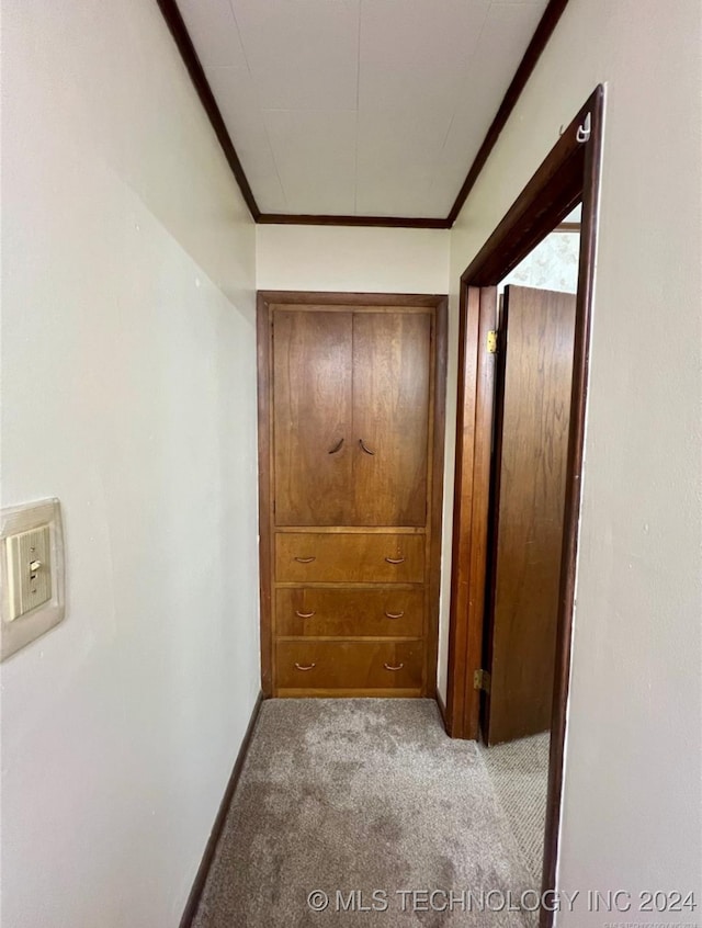 hall featuring light carpet and crown molding