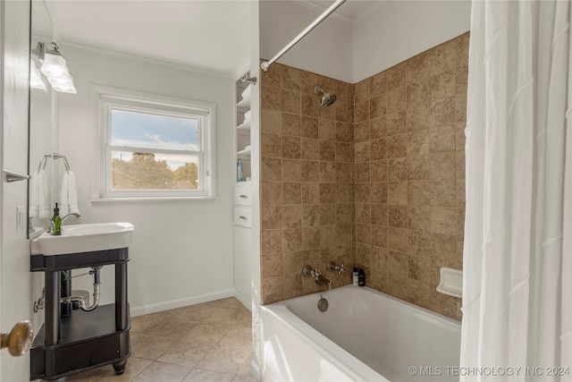 bathroom featuring tile patterned flooring, shower / bathtub combination with curtain, and sink