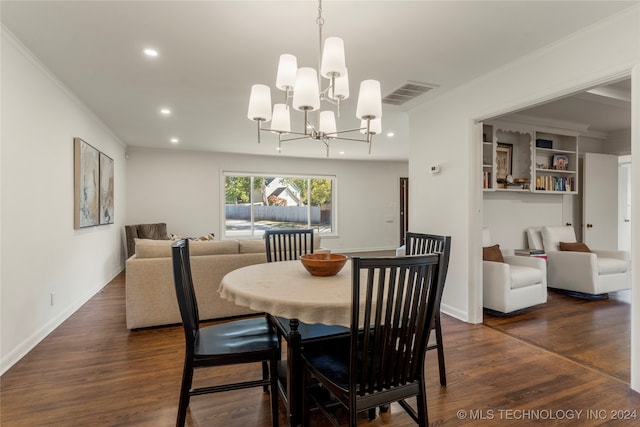 dining area featuring ornamental molding, a notable chandelier, and dark hardwood / wood-style floors