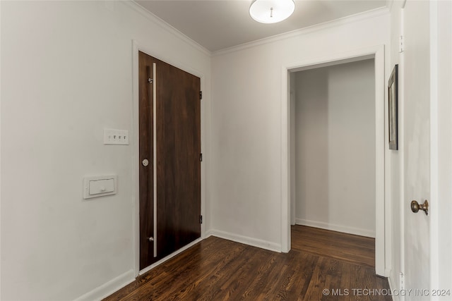 hall with ornamental molding and dark hardwood / wood-style floors