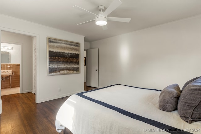 bedroom featuring dark wood-type flooring, ornamental molding, ceiling fan, and ensuite bath