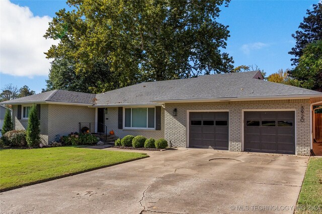 3920 S Utica Ave, Tulsa, OK 74105 - ranch-style home featuring an attached garage, brick siding, a front lawn, concrete driveway, and roof with shingles