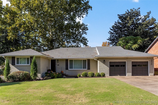 ranch-style house featuring a garage and a front lawn