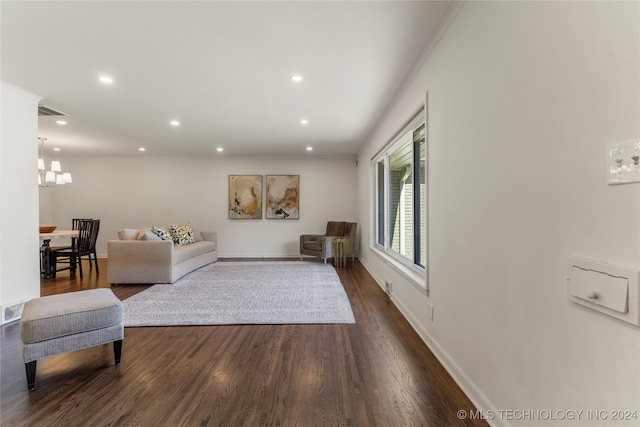 living room featuring dark hardwood / wood-style flooring and a chandelier