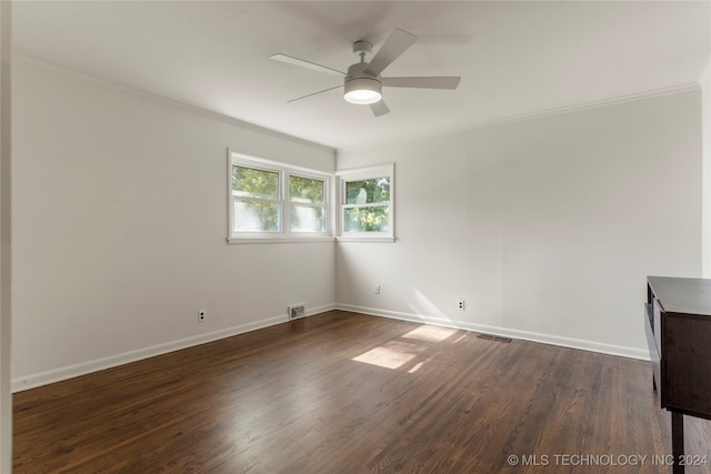 empty room with ceiling fan, dark hardwood / wood-style floors, and crown molding