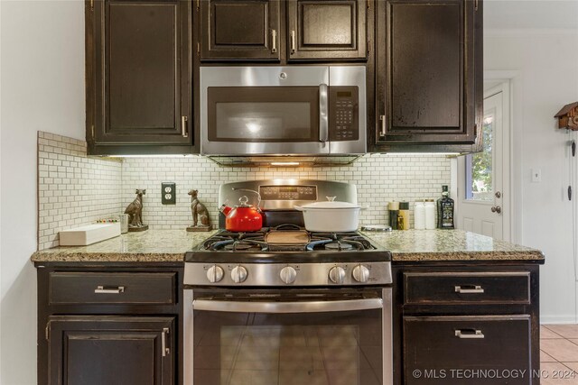 3920 S Utica Ave, Tulsa, OK 74105 - kitchen with stainless steel appliances, decorative backsplash, and dark brown cabinetry