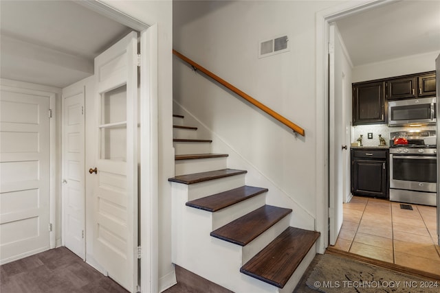 stairs with tile patterned floors