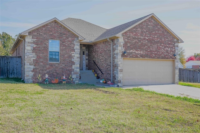 view of front of property with a garage and a front yard