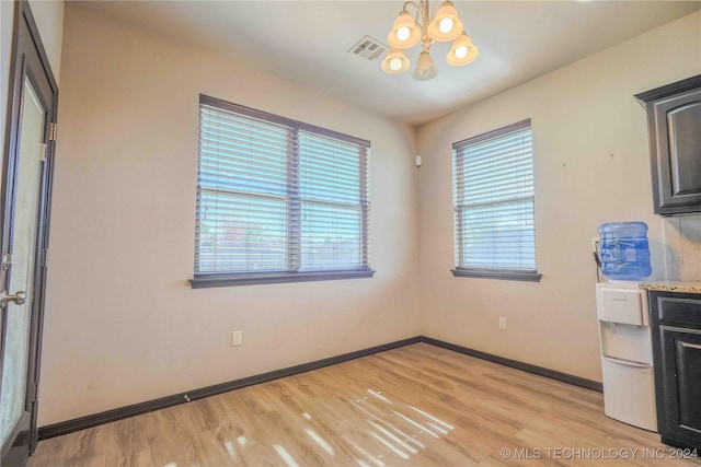 interior space with an inviting chandelier and light hardwood / wood-style flooring