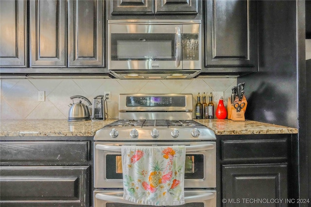 kitchen featuring decorative backsplash, light stone countertops, and stainless steel appliances