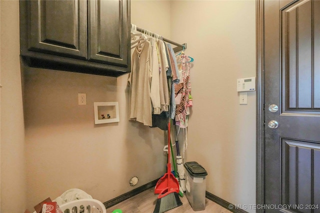 washroom with washer hookup and cabinets