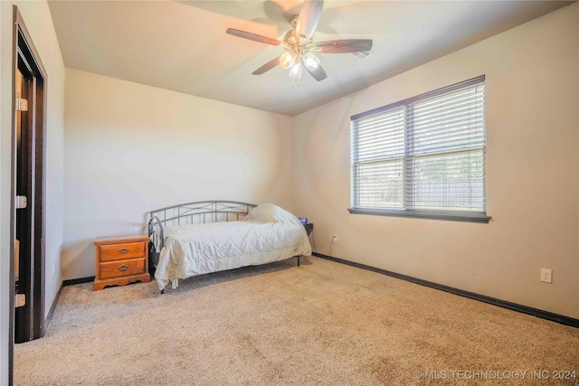 bedroom featuring ceiling fan and light carpet