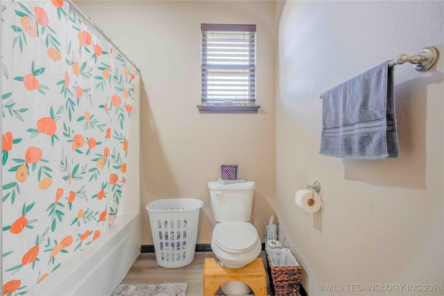 bathroom featuring toilet, shower / tub combo, and wood-type flooring