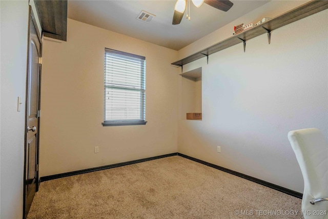 spare room featuring ceiling fan and light colored carpet